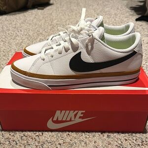 Nike White Sneakers with Black Swoosh and Gold Trim